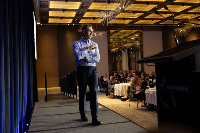 Gabe speaking to a full room at a business event