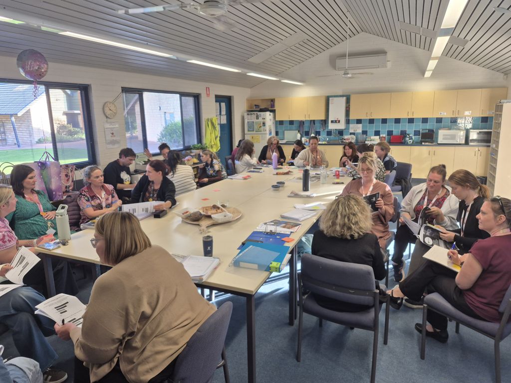 School staff working through a planning session in a staffroom