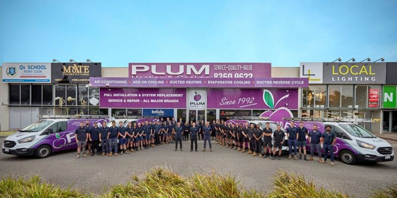 The Plum Heating & Cooling team outside their showroom